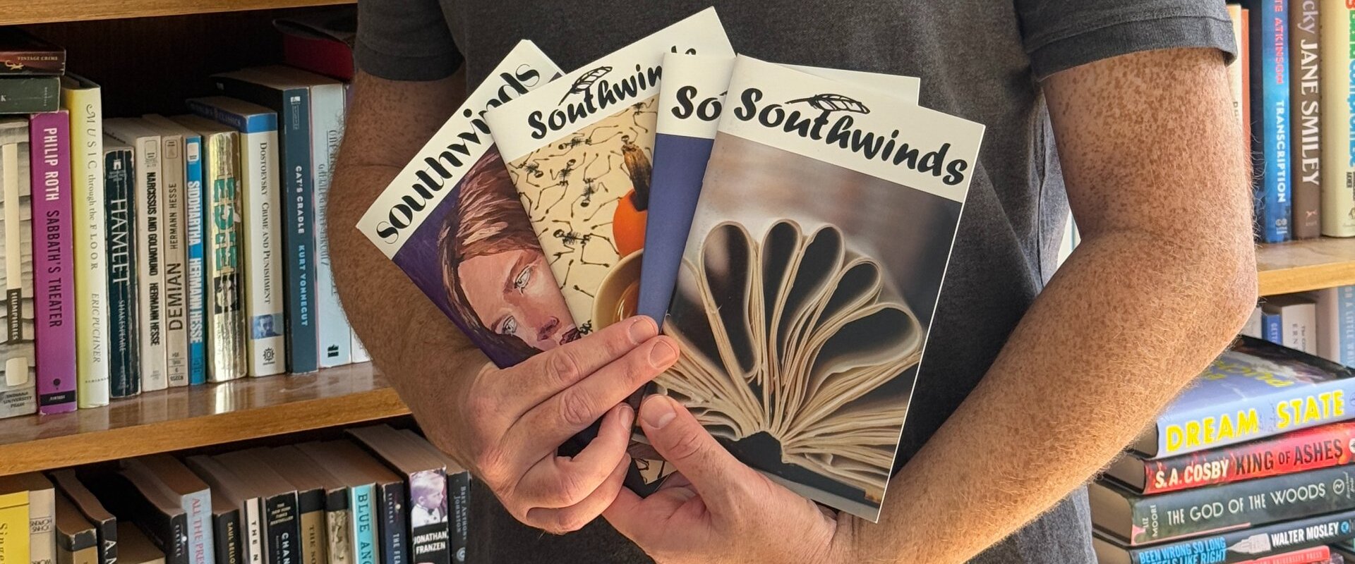 Professor Mathew Goldberg holding books in a library